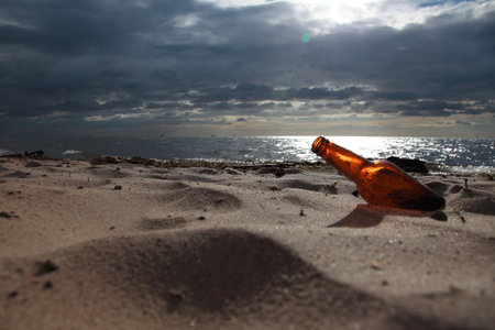 bottle on beach sea and skyの写真素材