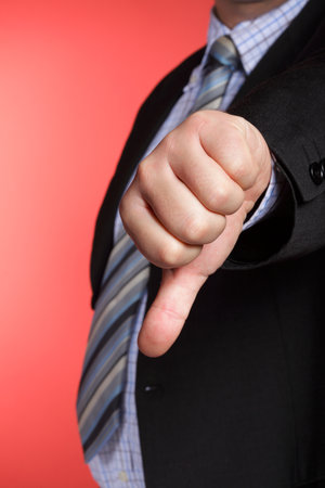 Business man showing thumb down - selective focus on handの写真素材