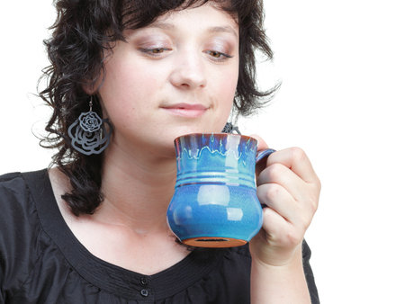 Young woman holding a blue cup, isolated on whiteの写真素材