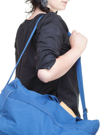 woman waving hand - goodbye in black and blue shoulder bag isolated on whiteの写真素材