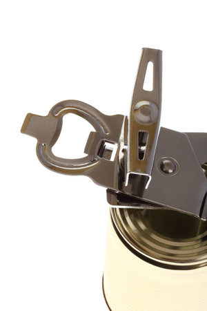 Tin opener opening a can of food isolated on white の写真素材