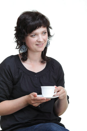 Young woman looking up holding a cup, isolated on whiteの写真素材