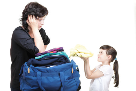 woman and baby daughter crammed full of clothes and blue shoulder bag isolated on whiteの写真素材