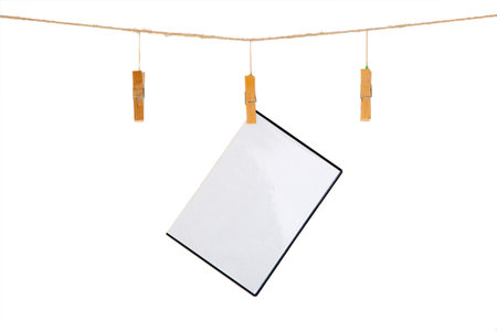 blank CD / DVD cover box with film or game sheet on a clothes line. Isolated on white background. 