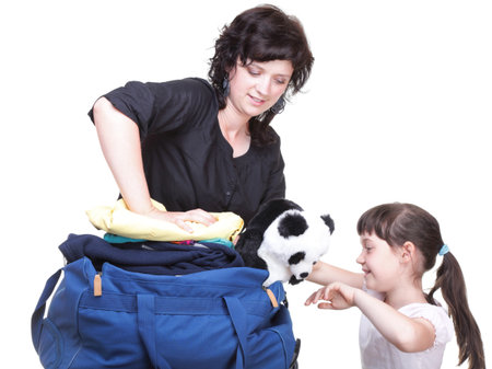 woman and baby daughter crammed full of clothes and blue shoulder bag isolated on whiteの写真素材
