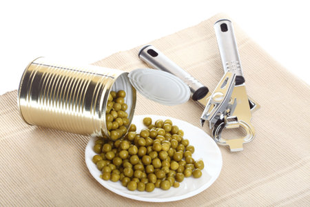 Tin opener opening a can of food canned, tinned peasの写真素材