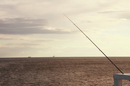  fishing rod, sea and sky at the pier, jettyの写真素材