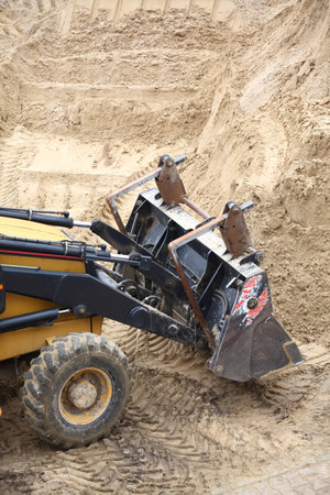 Yellow excavator on the construction siteの写真素材