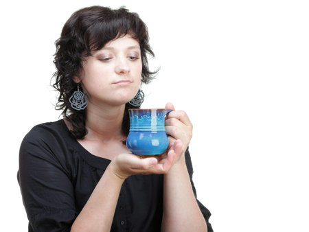 Young woman holding a blue cup, isolated on whiteの写真素材