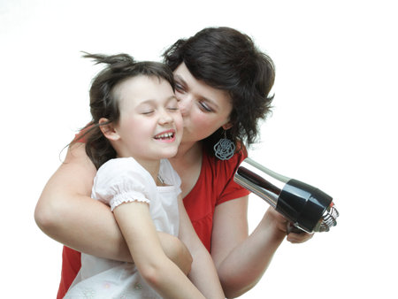 Pretty woman girl drying her hair hairdryer isolated on whiteの写真素材