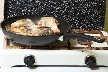 to pan-fry sth Raw cod fish fillets in kitchenの写真素材