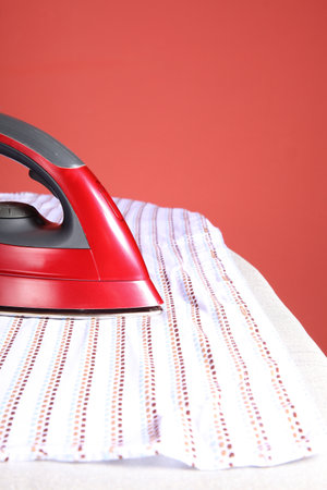 household chores - red iron  and white shirt 
の写真素材