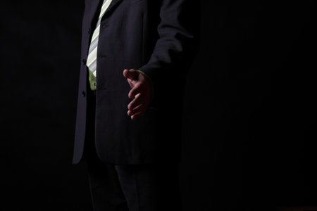 business man open hand ready to seal a deal red backgroundの写真素材