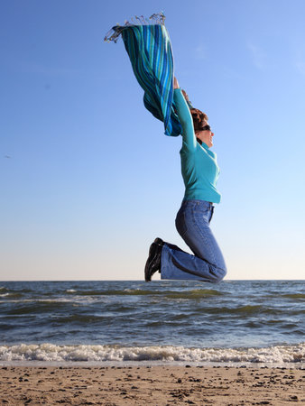 blue woman and shawl at sea shoreの写真素材