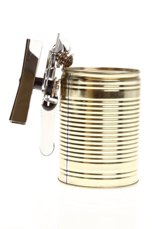 Tin opener opening a can of food isolated on white の写真素材
