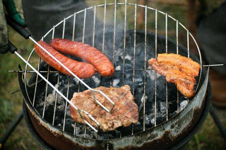 Flames grilling a steak on the BBQ bonfire, campfire summerの写真素材