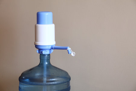 large bottle of water on a beige background in homeの写真素材
