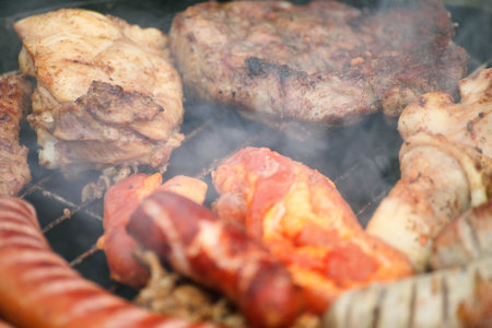Flames grilling a steak on the BBQ bonfire, campfire summerの写真素材