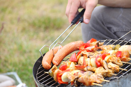 Flames grilling a steak on the BBQ bonfire, campfire summerの写真素材