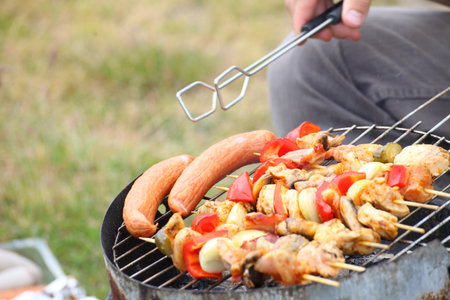 Flames grilling a steak on the BBQ bonfire, campfire summerの写真素材