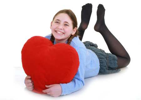 young teenager with red heart isolated on white backgroundの写真素材