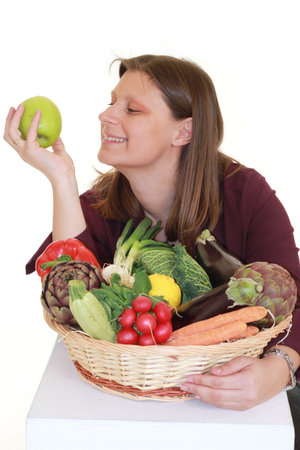 girl with vegetables basketの写真素材