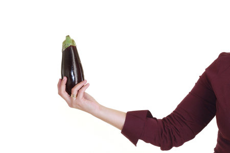 woman hand is holding a aubergineの写真素材
