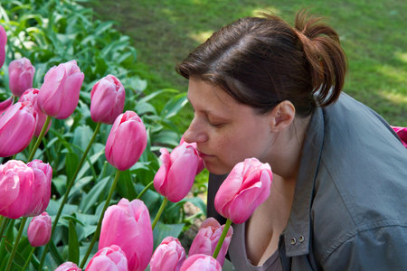 Pretty girl with tulips with soft background の写真素材