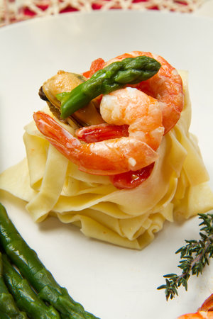 pasta with shrimp, mussels and fresh asparagusの写真素材
