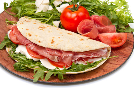italian piadina with ham, fresh salad and mozzarella cheeseの写真素材