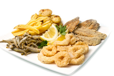 a dish with different fish fried and potateの写真素材