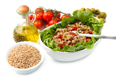 a dish with spelt salad with tomatoes,olive and saladの写真素材