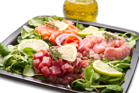 salmon, tuna and swordfish tartare with fresh saladの写真素材