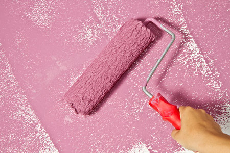 roller brush with pink painの写真素材
