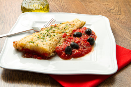 cooked cod loins with home made tomato sauce の写真素材