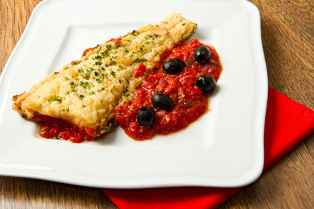 cooked cod loins with home made tomato sauce の写真素材