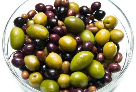 different kind of green and black olives on white backgroundの写真素材