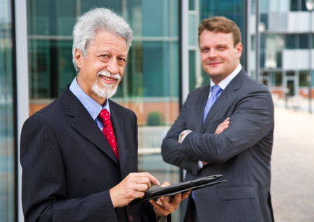 Two business men with a tabletの写真素材