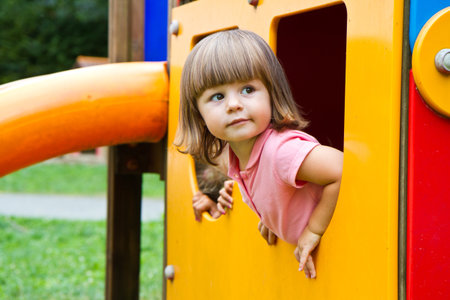 Happy smiling child  playing in a  playground area の写真素材