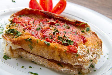 eggplants parmigiana on white dishの写真素材