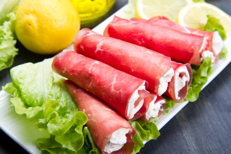 Dried beef and cheese on white dishの写真素材