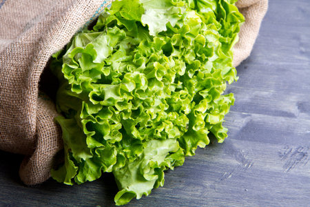 fresh salad in the burlap sack on wood