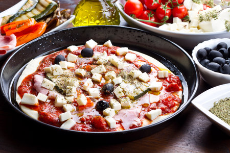 pizza with tomatoes,mozzarella,black olives and grilled vegetablesの写真素材