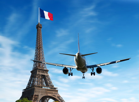 Airplane over Paris, France. Tourism and vacation concept.の写真素材