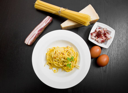 dish with spaghetti carbonara's and ingredientsの写真素材