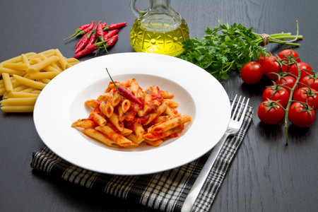 penne with arrabbiata sauce and fresh ingredientsの写真素材