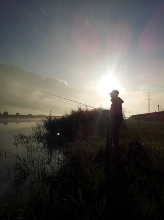 Silhouette of Fisherman at sunriseの写真素材