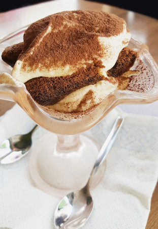 cup of tiramisu dusted with cocoa powder