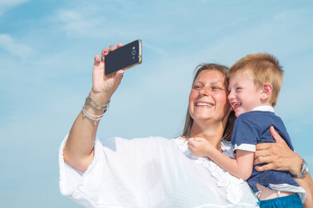 Mom and son are shooting a selfie smilingの写真素材