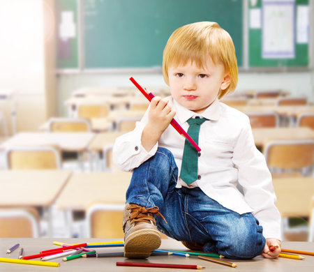 a little child handing colroed crayonsの写真素材